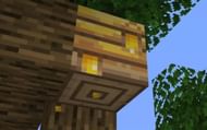 Honey can be seen dripping out of the hive (Image via Minecraft Wiki)